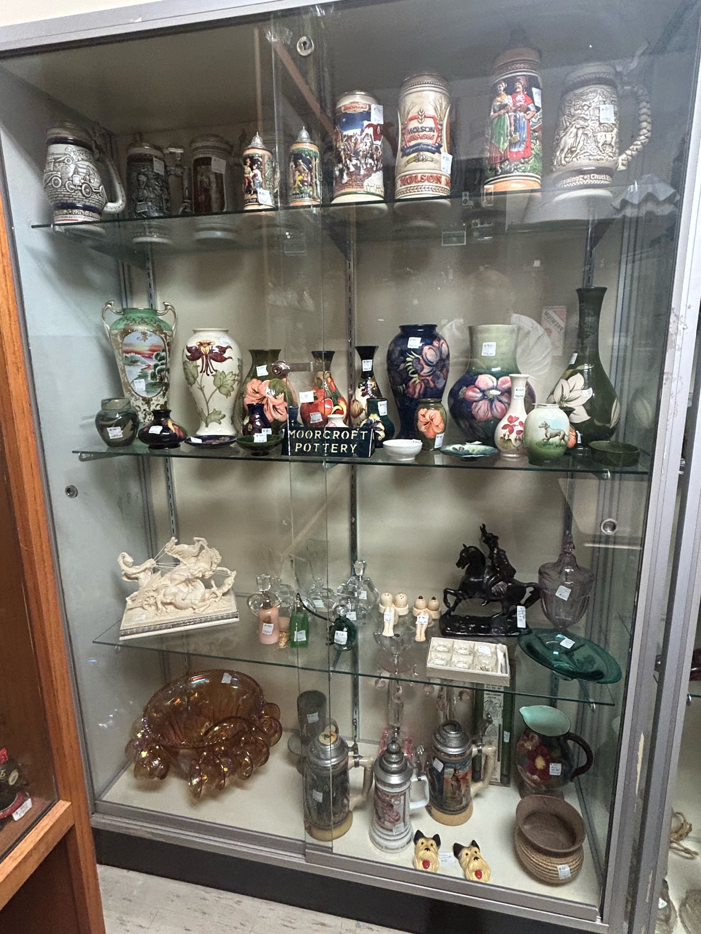 Vintage glassware and pottery display case at Krave Antiques in Regina