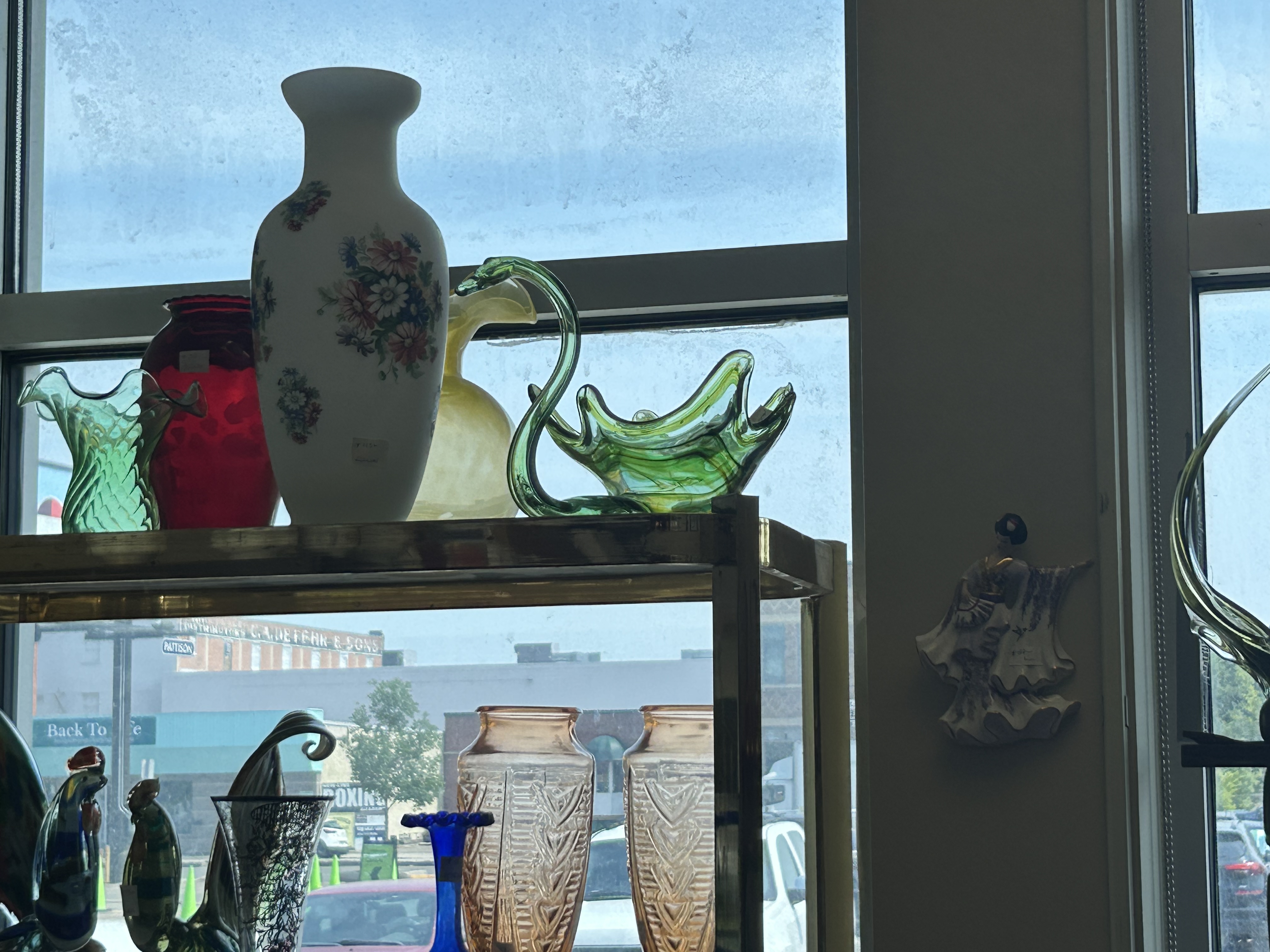 Colourful vintage glassware in window at Krave Antiques Regina