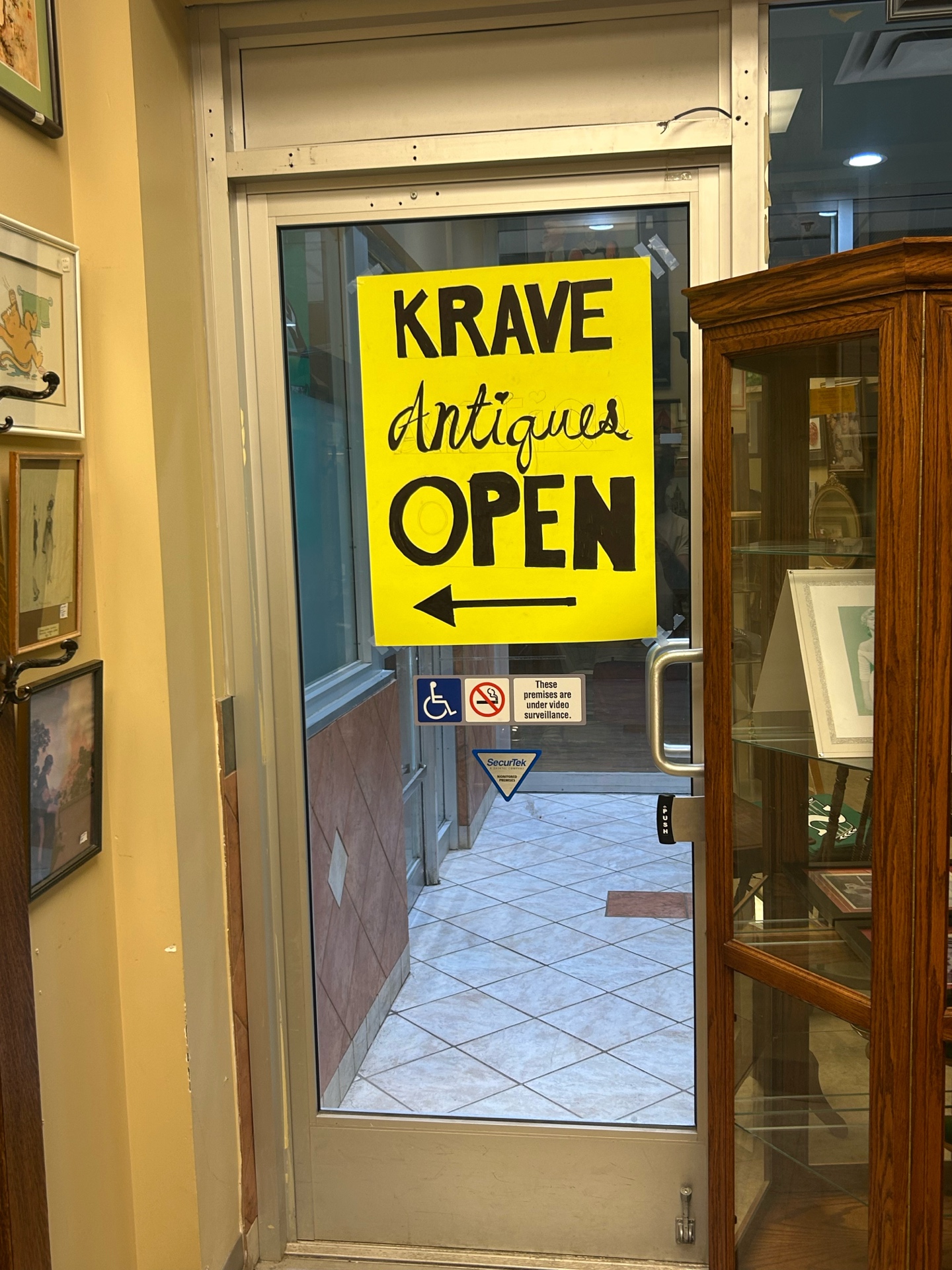 Krave Antiques bright yellow open sign in Regina Saskatchewan