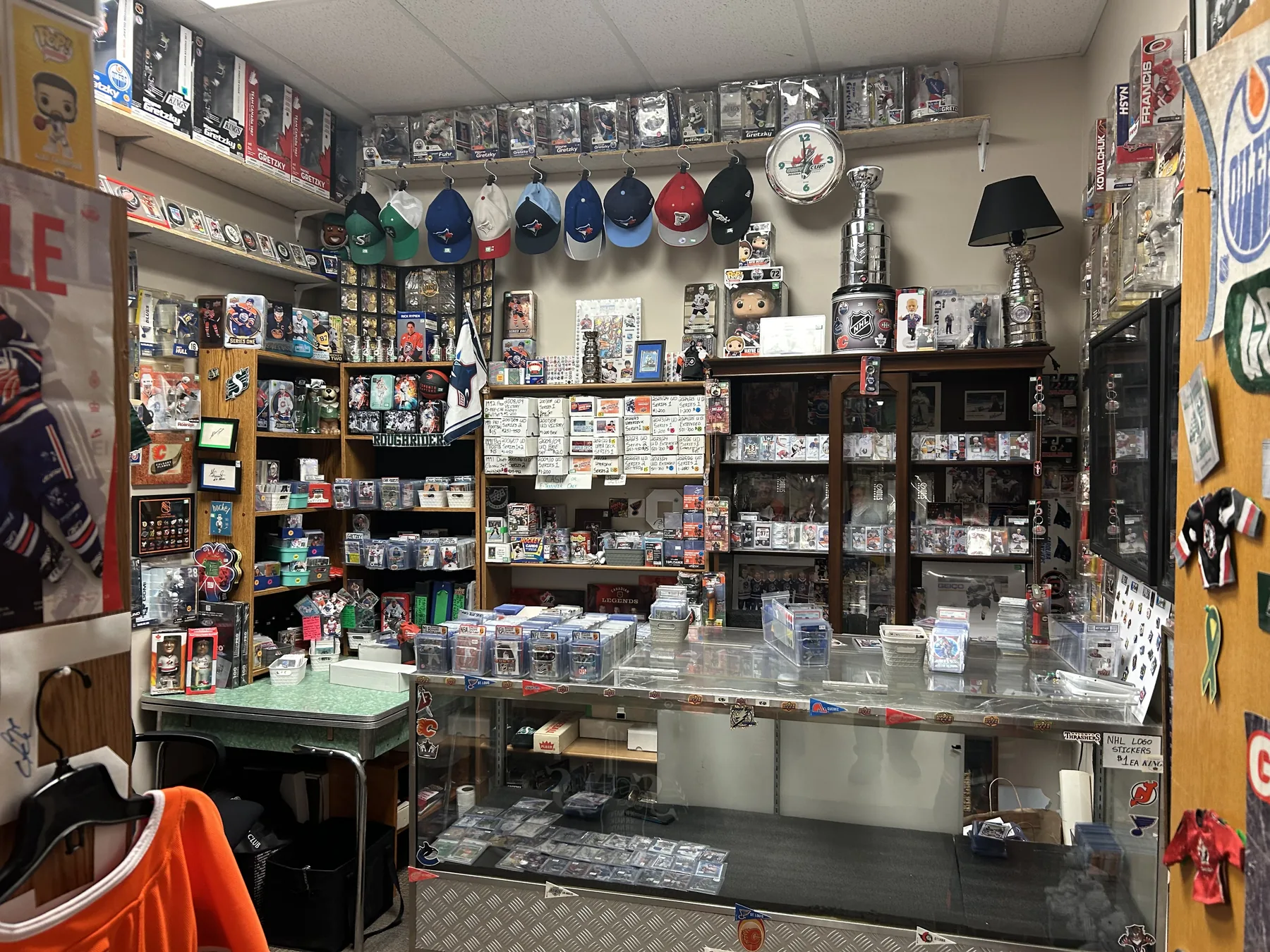 Sports cards, hockey memorabilia, team hats and collectables in the Sports Room at Krave Antiques Regina