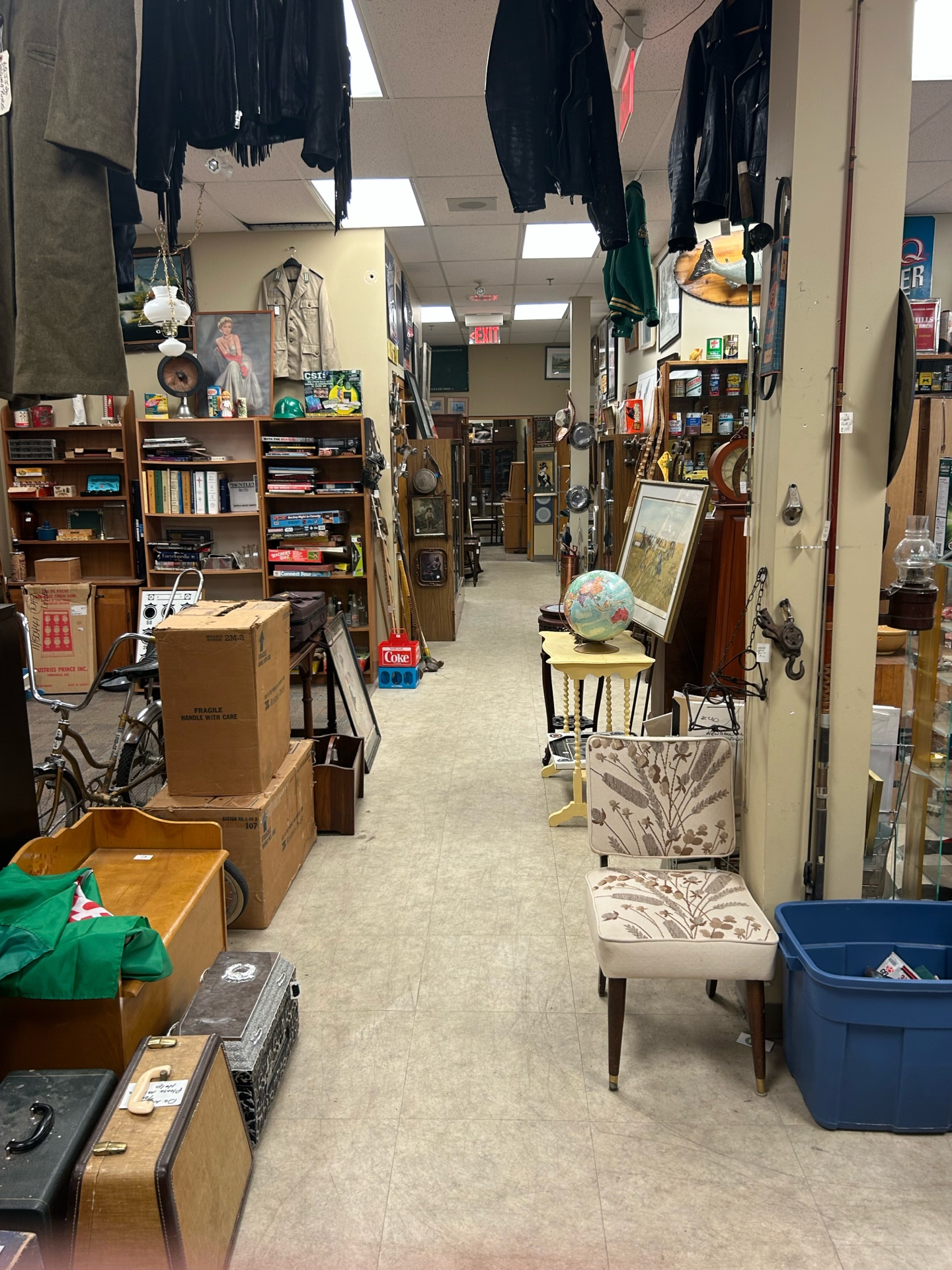 Looking down a packed aisle at Krave Antiques in Regina