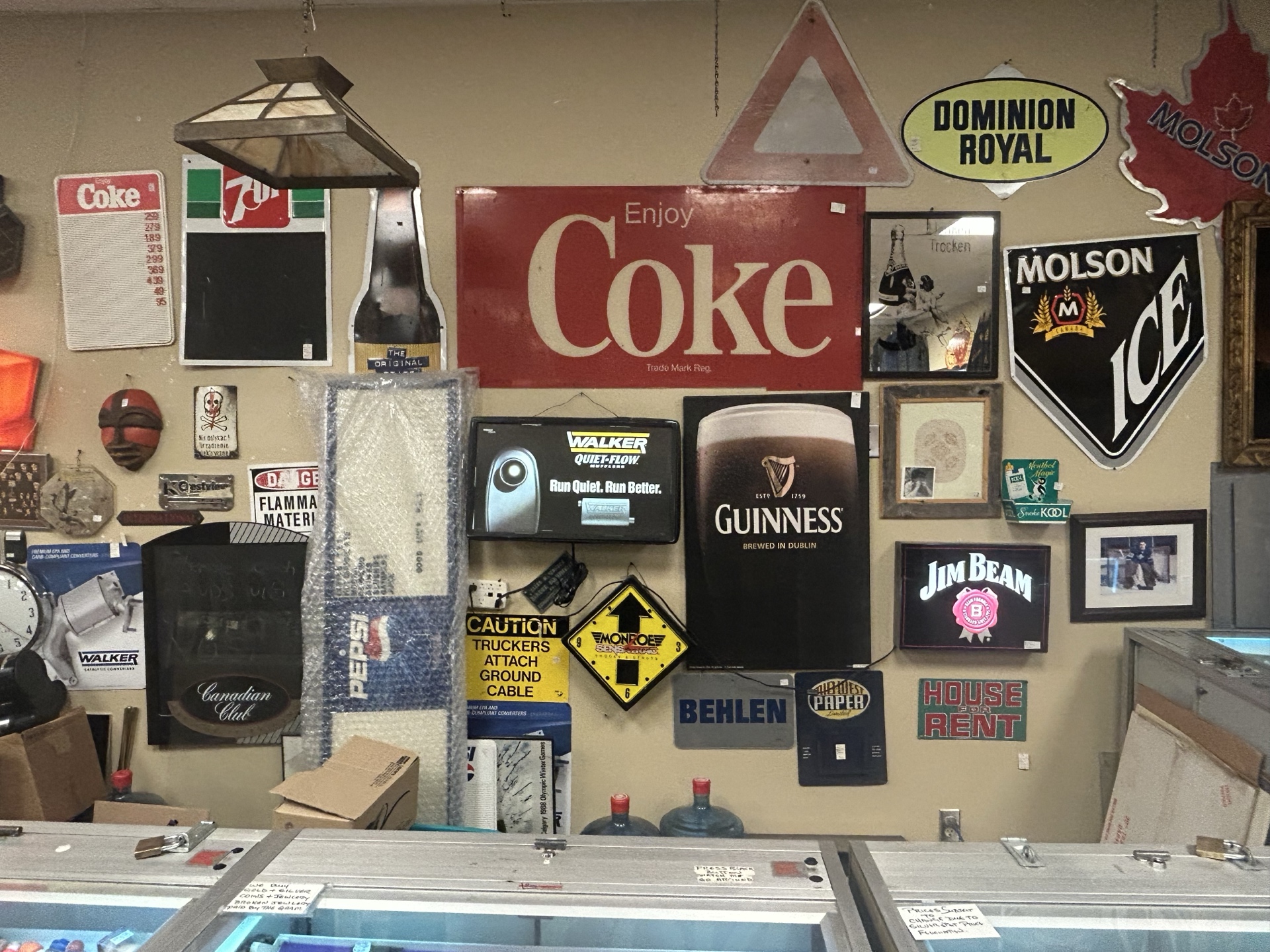 Wall of vintage advertising signs at Krave Antiques in Regina